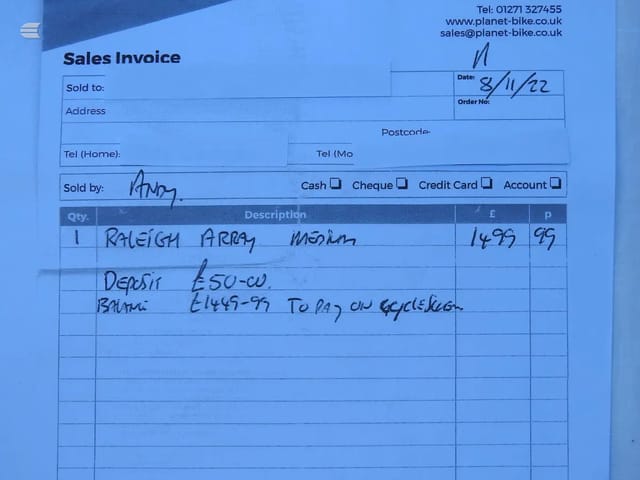 Sales invoice from Planet Bike, dated 8/11/22, showing handwritten details of a Raleigh Array Medium bike sale with deposit and balance payment terms.