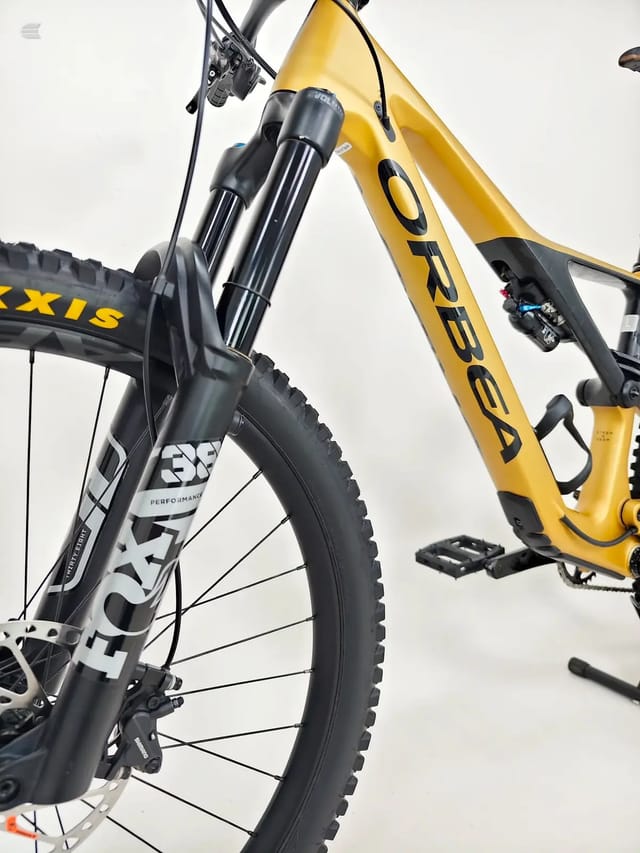 Yellow and black Orbea hardtail mountain bike, three-quarter view from the drive side, against a white background.