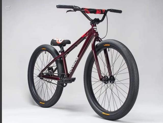 Maroon hardtail mountain bike with red and black handlebar grips, drive side, against a plain white background.